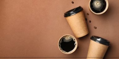 Cups of coffee on a brown background.